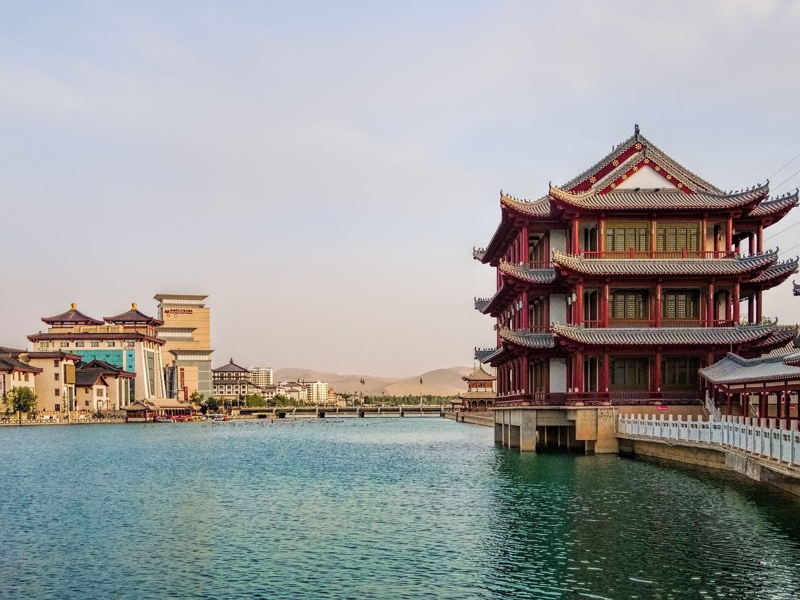 The waterfront along the Dang River is a stark contrast to the Mingshashan Sand Dunes that rise above the southern edge of the Dunhuang oasis.