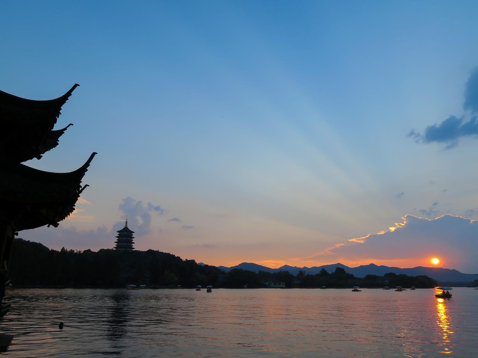 Sunset over West Lake with Leifeng Pagoda and pleasure boats, Hangzhou, China
