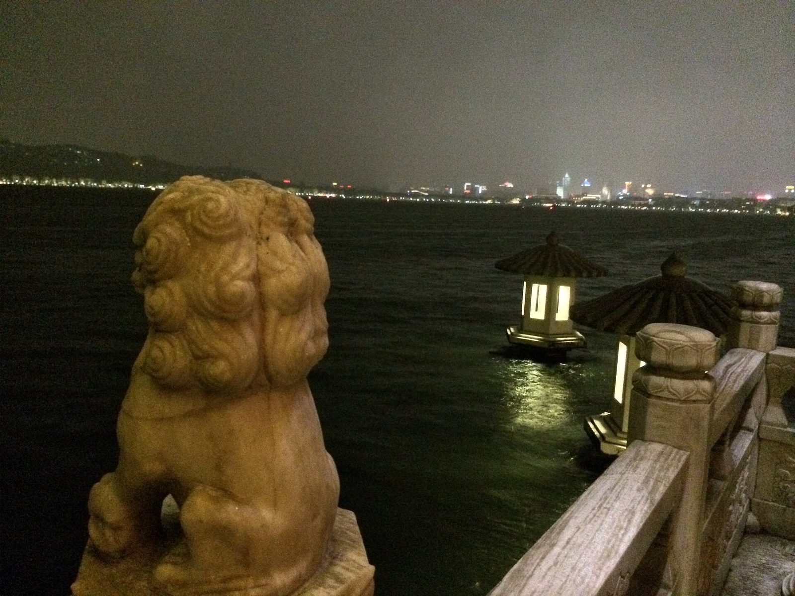 View of the night time Hangzhou skyline from the West Lake