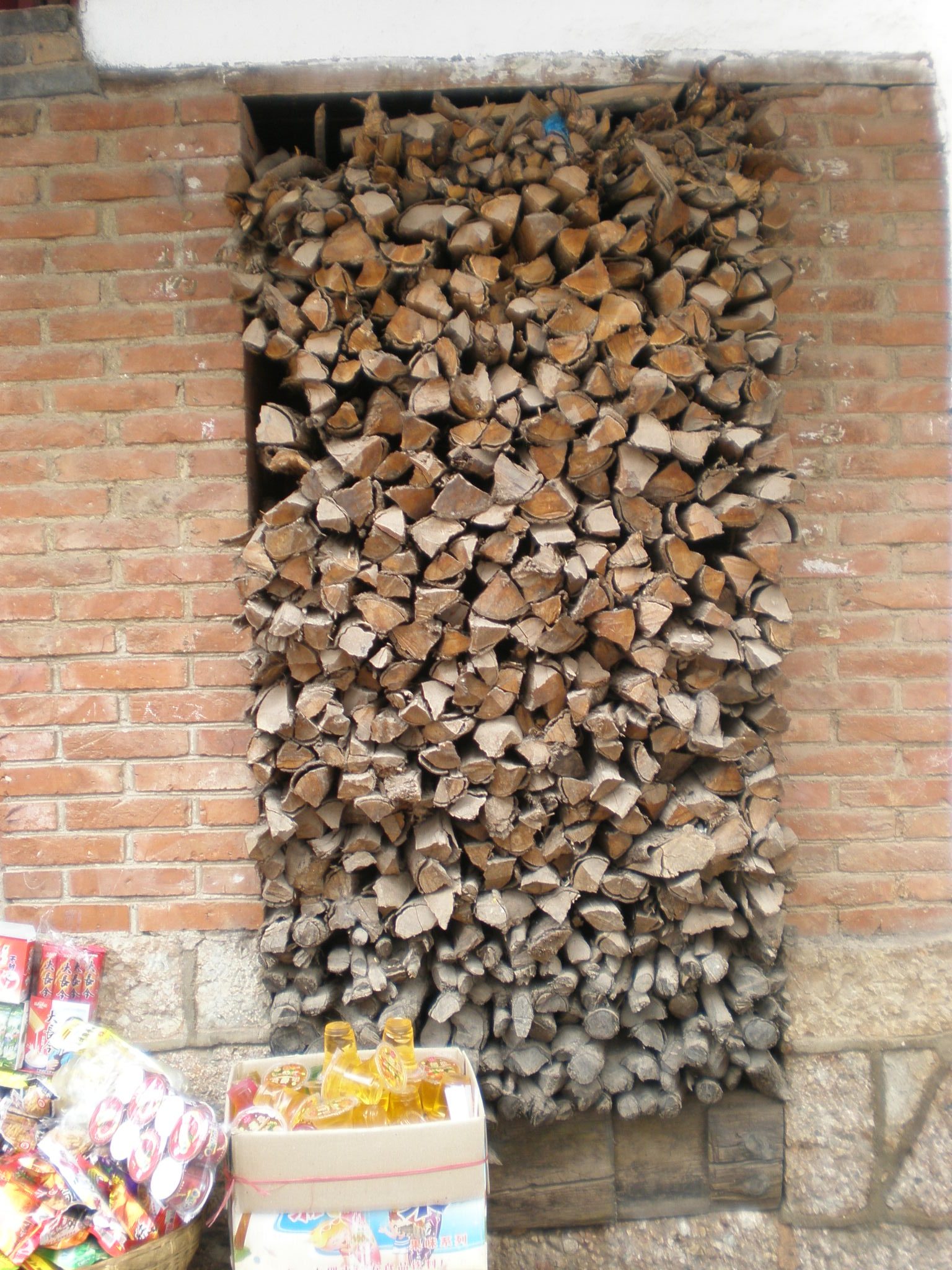 Firewood in a wall recess on Xinhua Street Upper Huangshan, in the Old Town of Lijiang, Yunnan.