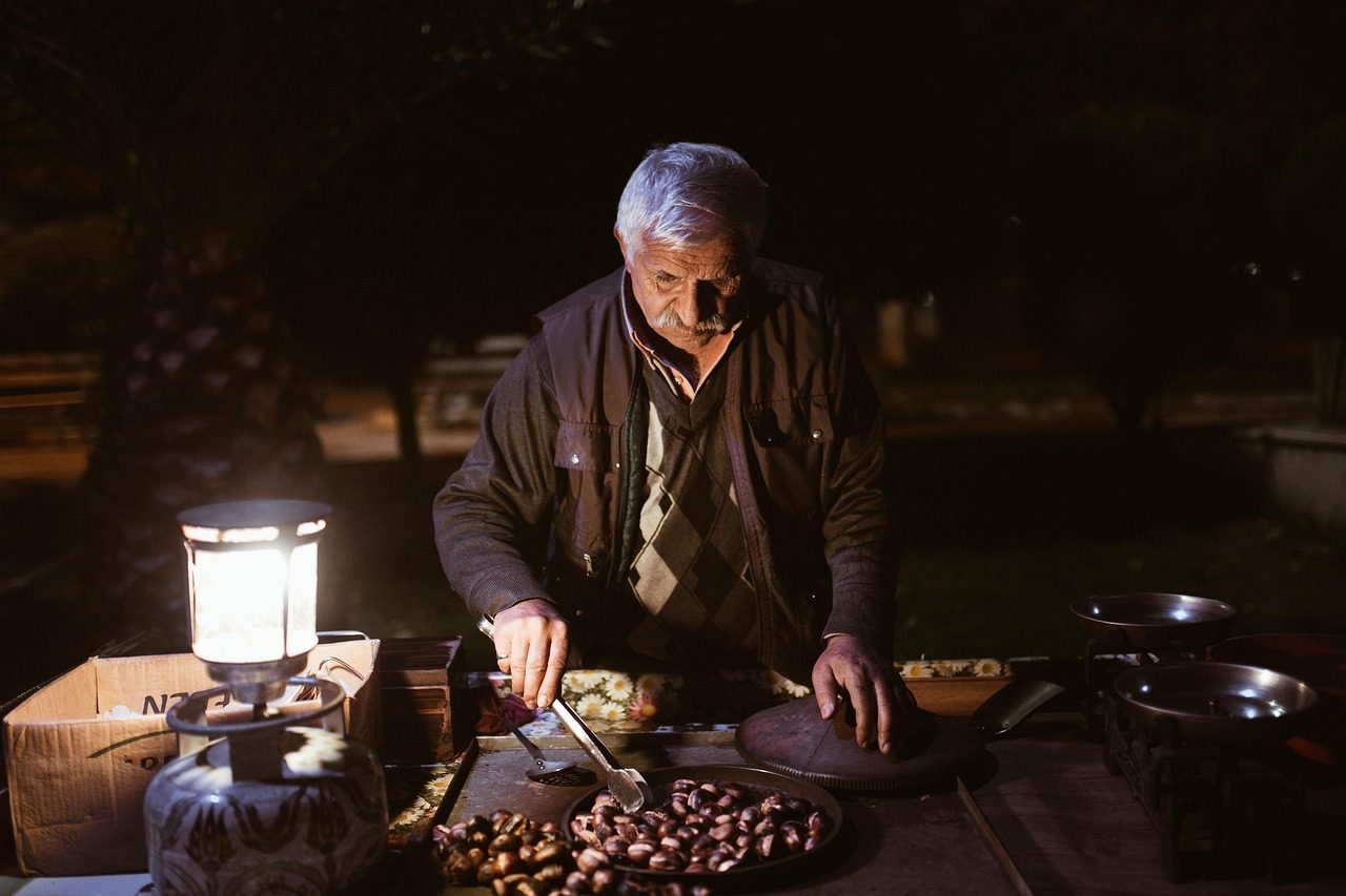 old man night chestnuts peddler street vendor vendor market night market elderly man old man old man old man old man old man market market
