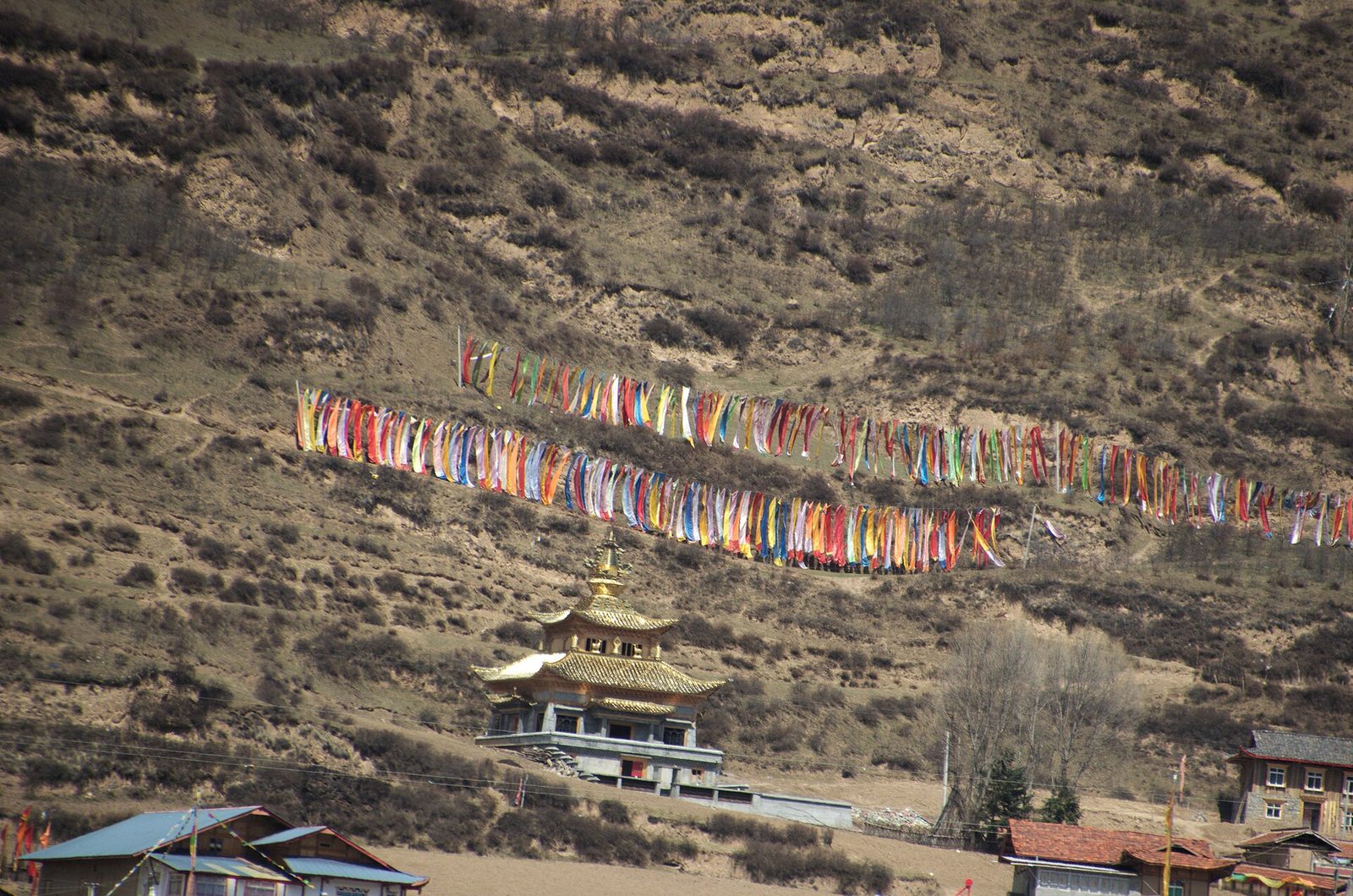 Sichuan province, Jiuzhaigou County Tibetan temple, with high rise prayer flag typical from this area.